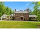 Traditional brick home with symmetrical facade, lush lawn, and mature trees at 500 Old Greensboro Rd, Chapel Hill, NC 27516