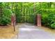 Grand gated entrance with brick pillars and decorative wrought iron at 500 Old Greensboro Rd, Chapel Hill, NC 27516
