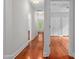 Hallway with hardwood floors and neutral walls leading to bedrooms and common areas at 500 Old Greensboro Rd, Chapel Hill, NC 27516