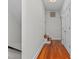 Hallway featuring hardwood floors, staircase access and white doors at 500 Old Greensboro Rd, Chapel Hill, NC 27516