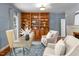 Inviting living room with custom wood built-ins, desk, plush armchairs and fireplace at 500 Old Greensboro Rd, Chapel Hill, NC 27516