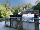 Well-equipped outdoor kitchen with stainless steel grill, countertop and stone base, perfect for entertaining at 500 Old Greensboro Rd, Chapel Hill, NC 27516