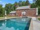 Inviting in-ground pool with stone surround, perfect for relaxation and entertaining by the home at 500 Old Greensboro Rd, Chapel Hill, NC 27516