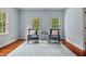 Bright sitting room with hardwood floors, plush armchairs, and beautiful natural light at 500 Old Greensboro Rd, Chapel Hill, NC 27516