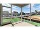 Screened-in back porch offering views of the spacious backyard and surrounding community at 552 Lemon Daisy Ln, Knightdale, NC 27545