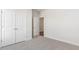 Bright bedroom featuring plush carpet, double door closet, and neutral paint creating a cozy and inviting atmosphere at 552 Lemon Daisy Ln, Knightdale, NC 27545