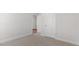 Empty bedroom featuring plush carpet, neutral paint, closet, and open doorway to let in natural light at 552 Lemon Daisy Ln, Knightdale, NC 27545