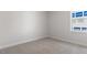 Empty bedroom featuring plush carpet, neutral paint and one window to let in natural light at 552 Lemon Daisy Ln, Knightdale, NC 27545