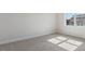 Bright bedroom with neutral carpet and a large window overlooking the neighborhood at 552 Lemon Daisy Ln, Knightdale, NC 27545