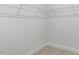 Empty walk-in closet features neutral carpet, white walls, and white wire shelving ready to be filled at 552 Lemon Daisy Ln, Knightdale, NC 27545