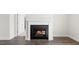 Living room fireplace with white mantle and dark brick, creating a warm, inviting space at 552 Lemon Daisy Ln, Knightdale, NC 27545