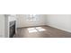 Bright living room with hardwood floors and large window offering view of the neighborhood at 552 Lemon Daisy Ln, Knightdale, NC 27545