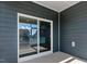Outdoor patio with modern sliding glass door and gray siding at 552 Lemon Daisy Ln, Knightdale, NC 27545