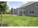 Spacious backyard with lush green grass and a charming screened-in porch at 556 Lemon Daisy Ln, Knightdale, NC 27545