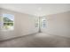 Comfortable bedroom featuring plush carpeting and abundant natural light from multiple windows at 556 Lemon Daisy Ln, Knightdale, NC 27545