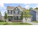Beautifully designed two-story home with a manicured lawn and gray exterior, showcasing modern living at 556 Lemon Daisy Ln, Knightdale, NC 27545