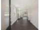 Inviting hallway with dark wood floors, neutral walls, and crown molding, leading to bright, airy rooms at 556 Lemon Daisy Ln, Knightdale, NC 27545