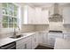 Bright kitchen with white cabinets, stainless steel appliances, and granite countertops, perfect for cooking at 556 Lemon Daisy Ln, Knightdale, NC 27545