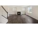 Spacious living room with a cozy fireplace and abundant natural light from large windows at 556 Lemon Daisy Ln, Knightdale, NC 27545