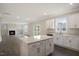 Open-concept kitchen and living area with wood floors, a fireplace, and lots of natural light at 556 Lemon Daisy Ln, Knightdale, NC 27545