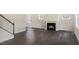 Living room featuring a fireplace, abundant natural light and sleek hardwood floors at 556 Lemon Daisy Ln, Knightdale, NC 27545