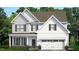 Charming two-story home with white siding, dark shutters, and a well-manicured lawn at 560 Lemon Daisy Ln, Knightdale, NC 27545