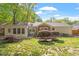 Landscaped backyard featuring a patio and a sunroom at 5713 Old Forge Cir, Raleigh, NC 27609