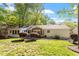 Green backyard featuring a sunroom and mature trees at 5713 Old Forge Cir, Raleigh, NC 27609