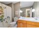 This bathroom features wood cabinets, a white countertop, a shower with a patterned curtain, and a large mirror at 5713 Old Forge Cir, Raleigh, NC 27609