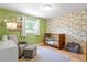 room with green walls, playful wallpaper, and a cozy wooden crib at 5713 Old Forge Cir, Raleigh, NC 27609