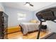 Cozy bedroom featuring hardwood floors, a comfortable bed with a padded storage bench, and ample natural light at 5713 Old Forge Cir, Raleigh, NC 27609