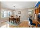 Sunlit dining room with a wooden table, seating for four, and hardwood floors at 5713 Old Forge Cir, Raleigh, NC 27609