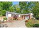 Charming brick home featuring a driveway, garage, and manicured landscaping at 5713 Old Forge Cir, Raleigh, NC 27609