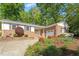 Charming brick home featuring a driveway, garage, and manicured landscaping at 5713 Old Forge Cir, Raleigh, NC 27609