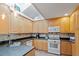 Well-lit kitchen featuring wooden cabinets, stainless steel appliances, and sleek countertops at 5713 Old Forge Cir, Raleigh, NC 27609