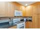 Close-up view of the kitchen featuring a stove, microwave, and plenty of cabinet space at 5713 Old Forge Cir, Raleigh, NC 27609