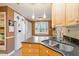 Kitchen featuring a spacious island with seating and stainless steel sink at 5713 Old Forge Cir, Raleigh, NC 27609