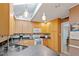 Bright kitchen with wooden cabinets, granite countertops, and modern pendant lighting at 5713 Old Forge Cir, Raleigh, NC 27609