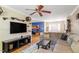 Bright living area with a large television, wood floors, and a comfortable sectional sofa at 5713 Old Forge Cir, Raleigh, NC 27609