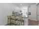 Bright kitchen featuring granite counters, white cabinets, stainless steel appliances, and a breakfast bar at 600 Sweet Iris Dr, Knightdale, NC 27545