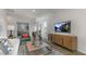 Cozy living room with comfortable seating, modern decor, and a large screen TV at 600 Sweet Iris Dr, Knightdale, NC 27545