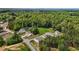 Aerial view of a neighborhood featuring homes with spacious lots and surrounded by lush greenery at 6007 Austin Falls Ct, Liberty, NC 27298