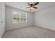 Well-lit bedroom with neutral carpet, ceiling fan, two windows with blinds, and neutral walls at 6007 Austin Falls Ct, Liberty, NC 27298