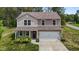 Two-story home with neutral siding, a two-car garage, and a covered front porch at 6007 Austin Falls Ct, Liberty, NC 27298