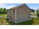 Back corner of the two-story home with neutral siding and a sliding door to the backyard at 6007 Austin Falls Ct, Liberty, NC 27298