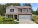 Charming two-story home with a well-manicured lawn and an attached two-car garage at 6007 Austin Falls Ct, Liberty, NC 27298