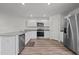 Modern kitchen featuring stainless steel appliances, granite countertops, and white cabinets at 6007 Austin Falls Ct, Liberty, NC 27298