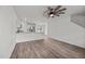 Open-concept living room featuring hardwood floors, modern ceiling fan, and an eat in kitchen at 6007 Austin Falls Ct, Liberty, NC 27298