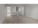 Open upstairs landing with neutral carpet, leading to various doorways and a bright window view at 6007 Austin Falls Ct, Liberty, NC 27298