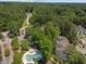 Overhead picture of the condo community displays the pool, landscaping, and surrounding mature trees at 6120 Sunpointe Dr # 102, Raleigh, NC 27606